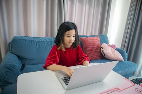 Focused girl engaged in typing practice at home