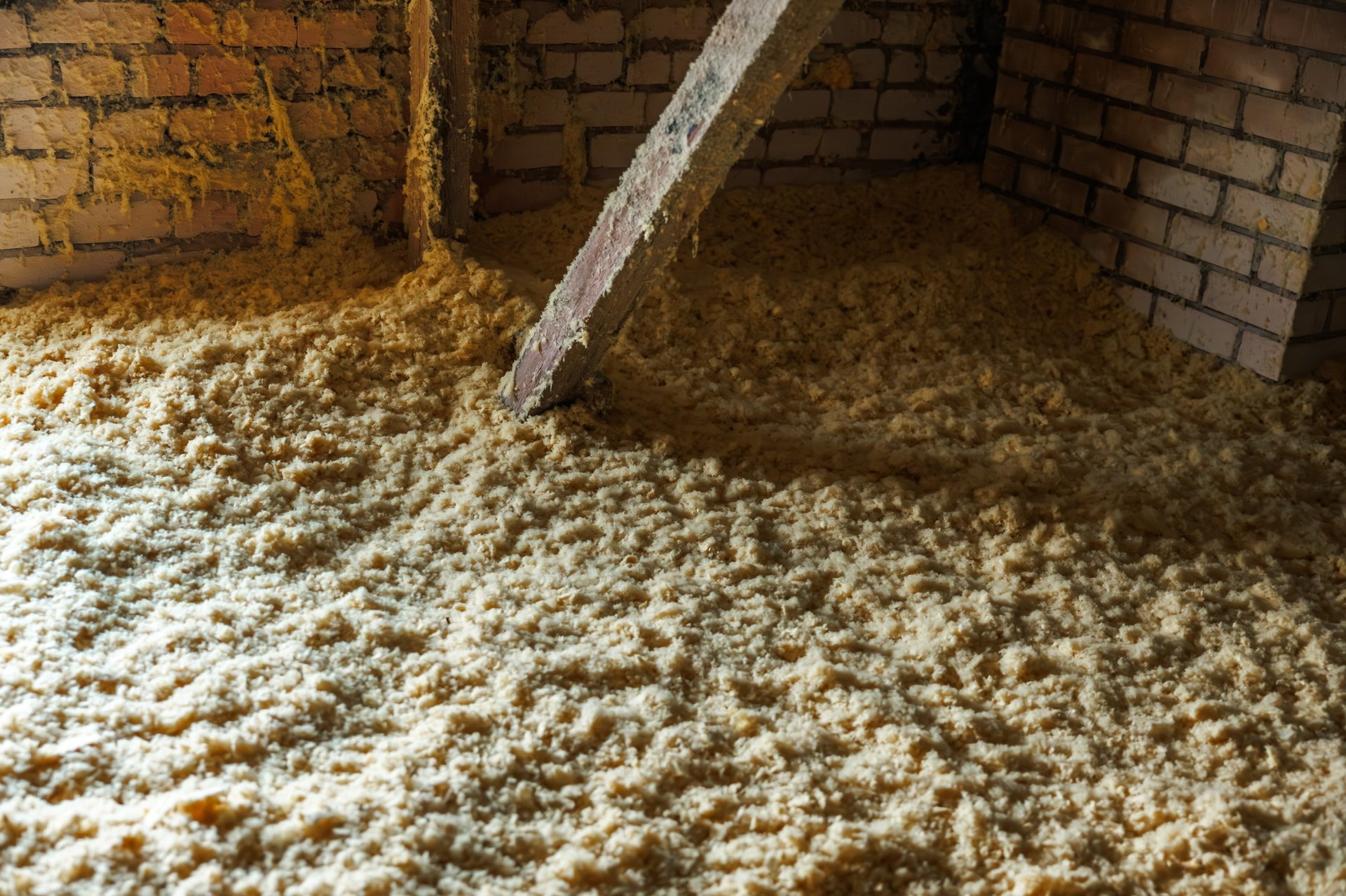 Blown cellulose insulation blanketing an attic floor