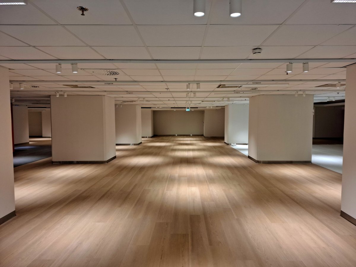 Large empty event venue with polished floors ready for cleanup