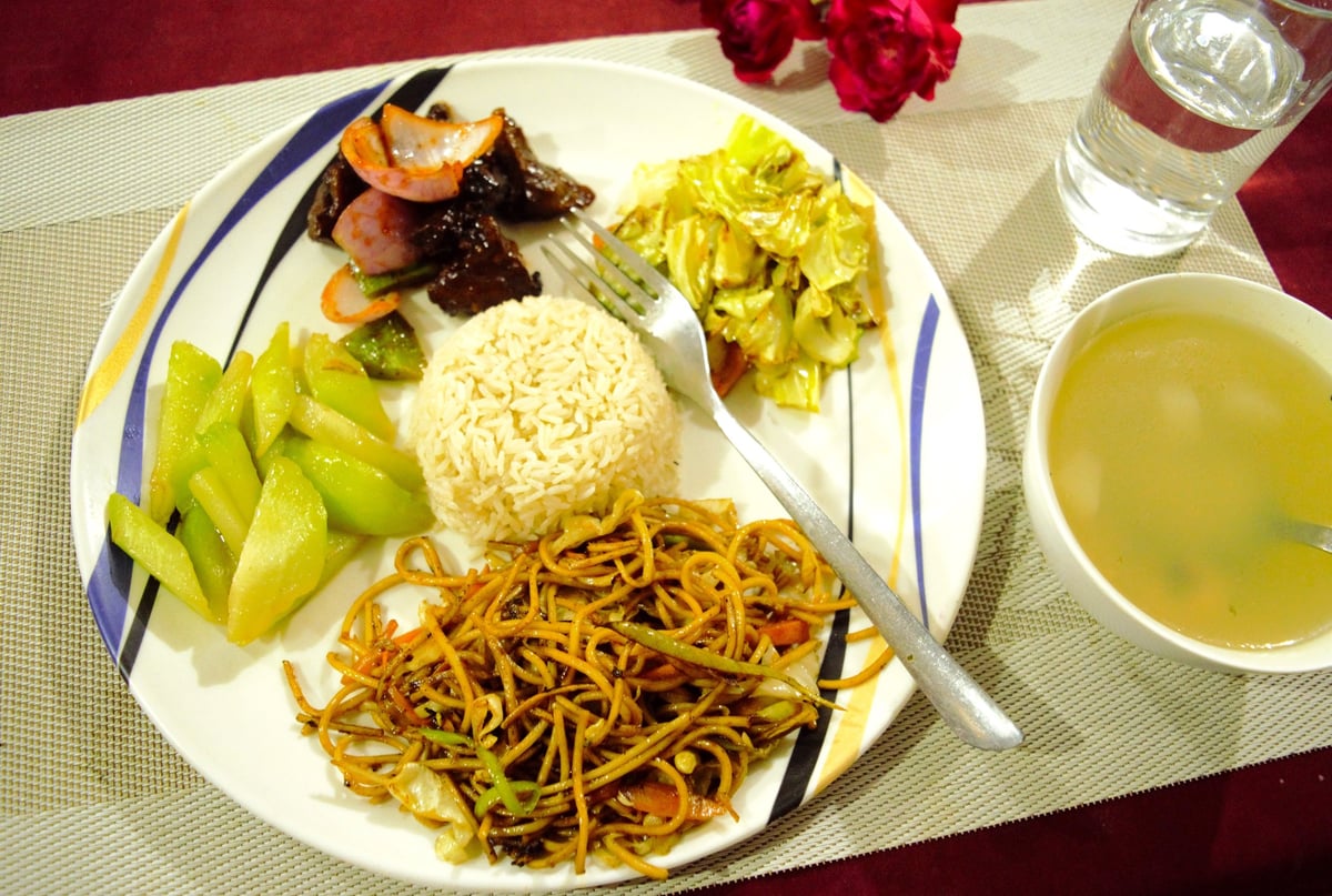 Traditional Nepali plate lunch with dal, rice, curry, and pickles
