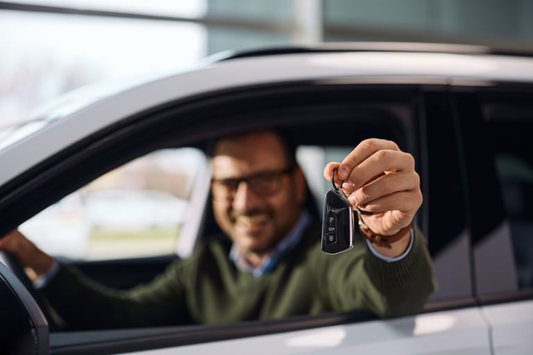 Man holding key of his new car