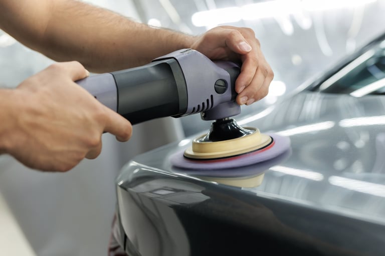 Man using an orbital polisher on a car to remove swirls and restore gloss — KJAJ Details paint correction