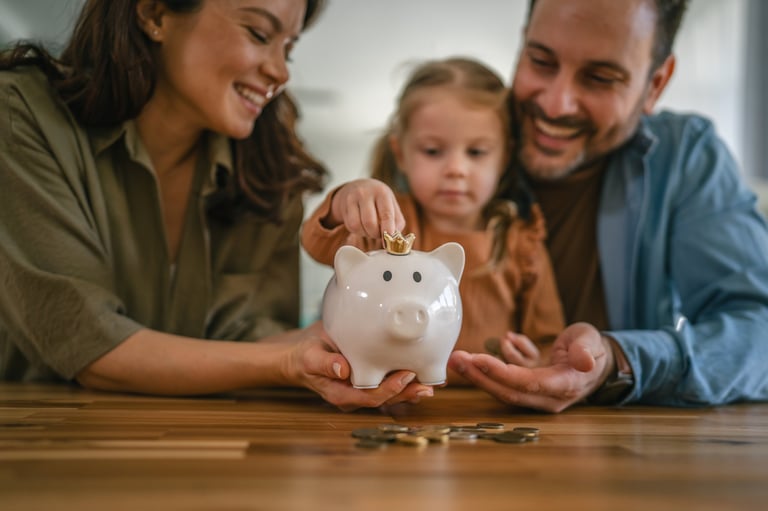 Young family engaging in financial education with child putting coins into piggy bank