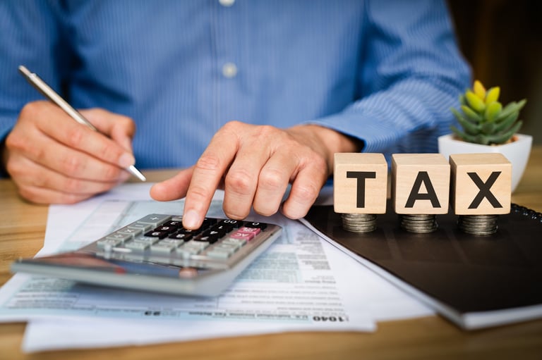Business professional calculating tax with financial documents