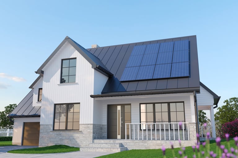 Modern house with rooftop solar panels installed on a dark metal roof under clear blue sky