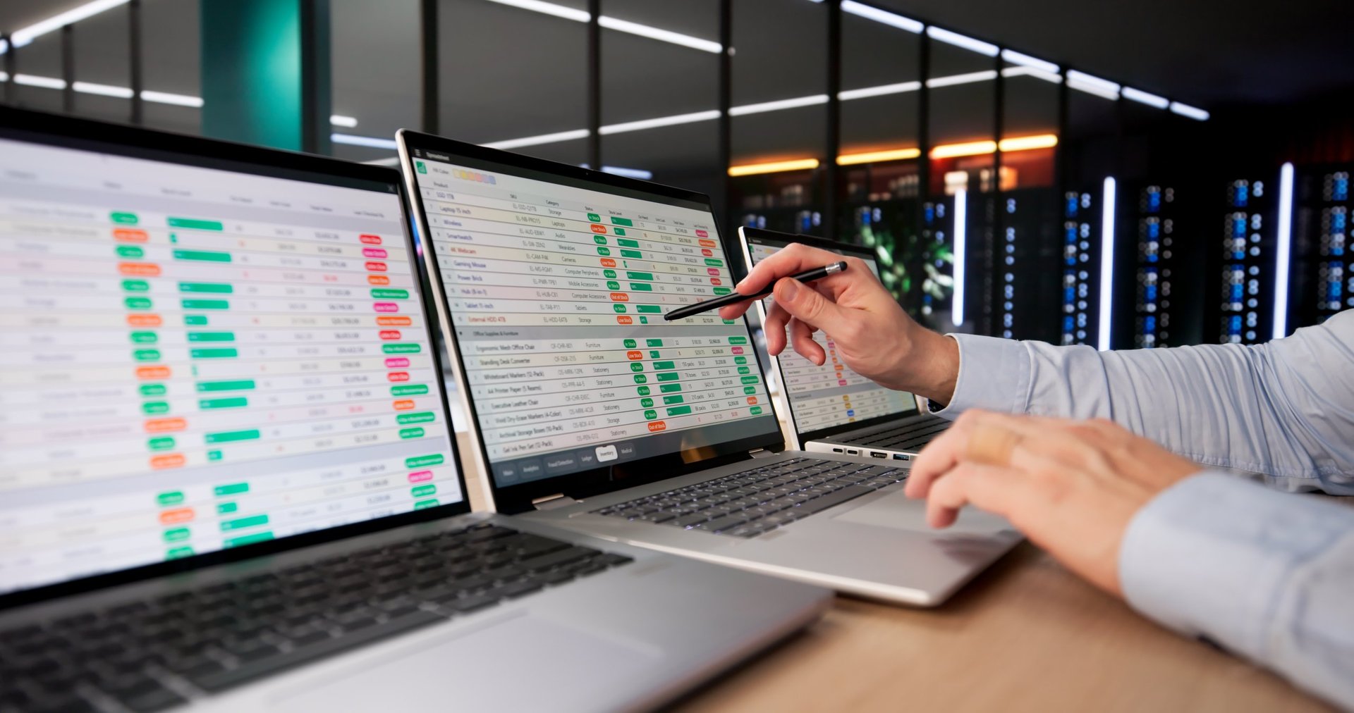 Financial analyst tracking data and insurance claims on laptop