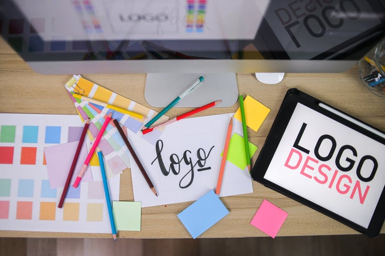 Top-down view of a designer's desk with pencils and color swatches
