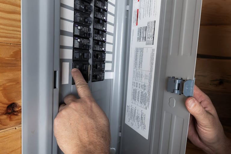 Homeowner inspecting electrical breakers or fuse box