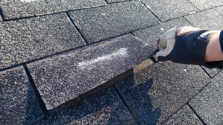 Roofing professional performing a hands-on maintenance check