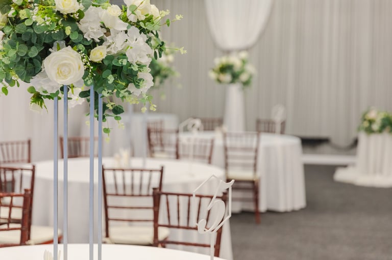 Elegant table setting with white flower arrangements in a luxury restaurant