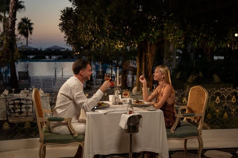 Couple sharing a romantic outdoor meal at sunset