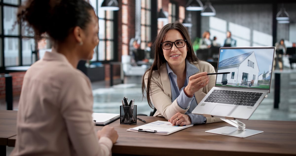 Buyer discussing financing options with an agent in a real estate office