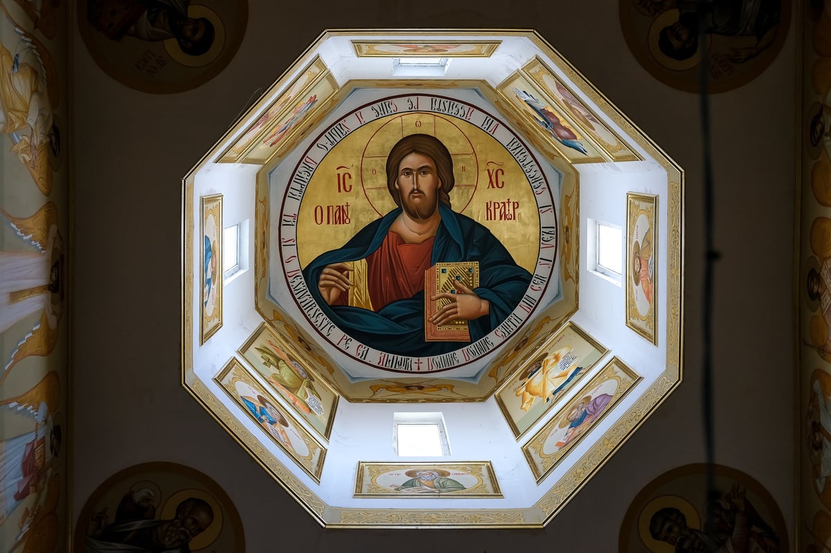Orthodox Church dome interior featuring Christ Pantocrator surrounded by saints and golden iconography