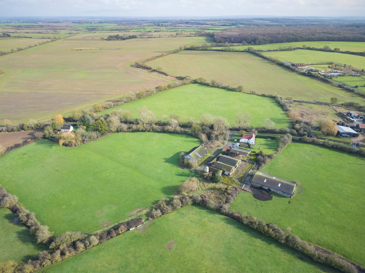 Aerial view of a rural farm estate with outbuildings