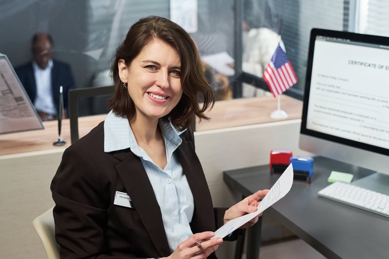 Woman holding documents at visa center desk with American flag