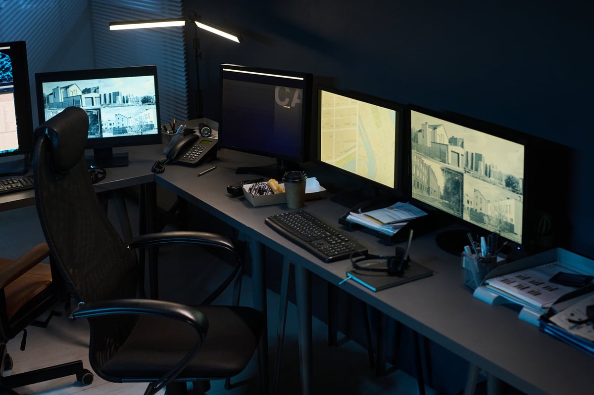 Modern workspace with monitors displaying building surveillance and monitoring data