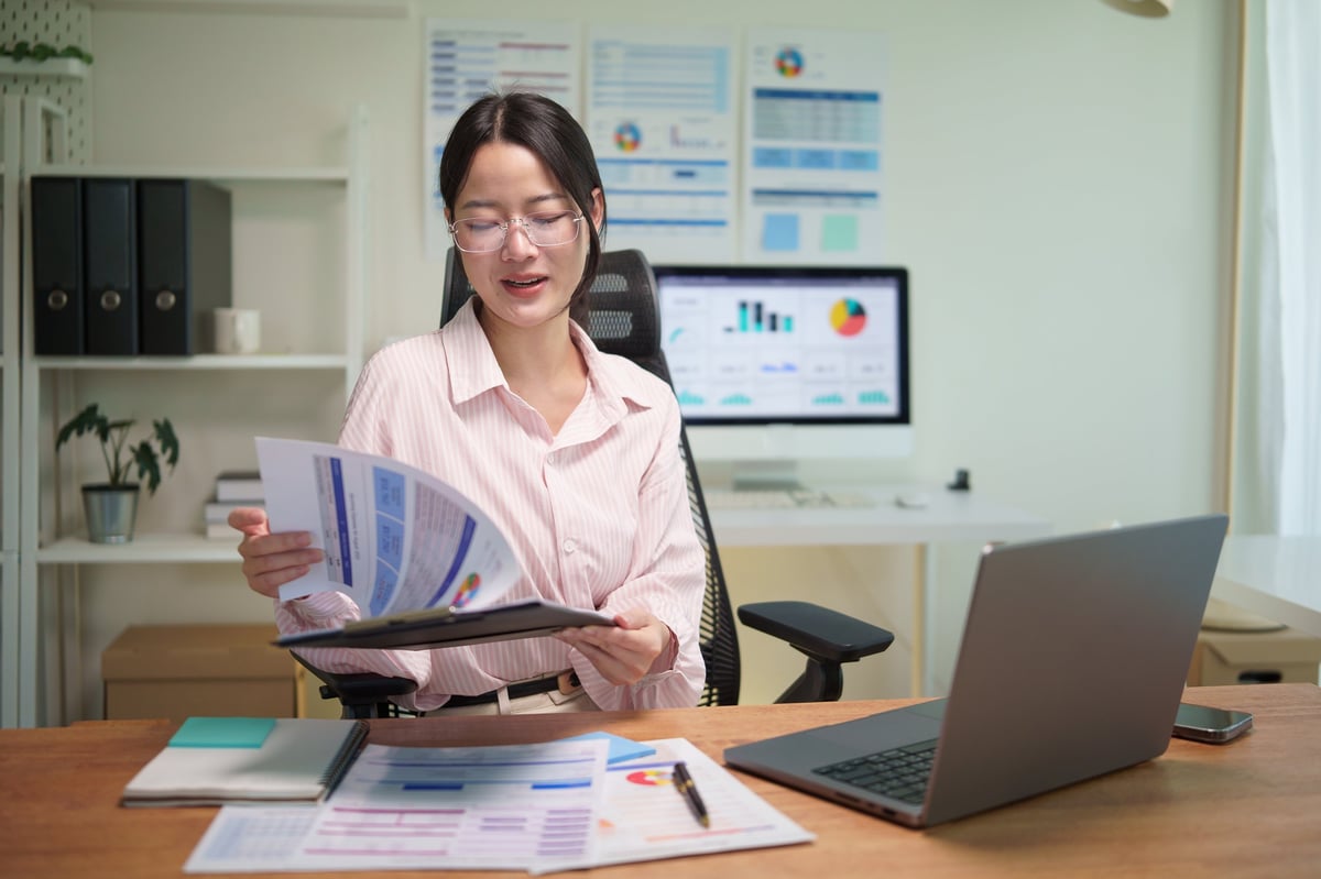 Business owner and Taycan Advisors reviewing revenue-based financing options and growth capital documents