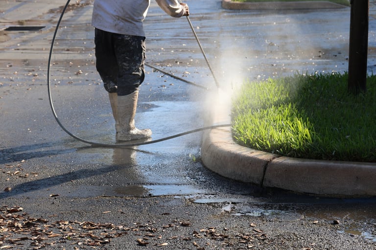 High-pressure driveway cleaning — removing oil stains and tire marks from asphalt