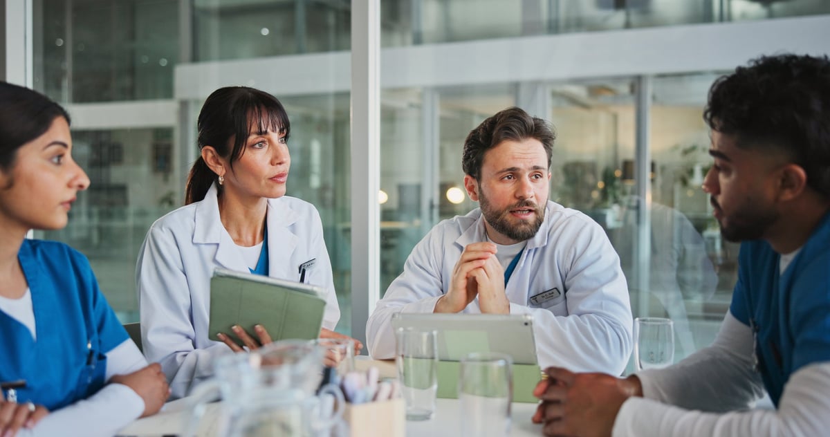 Meeting, team and nurses with doctors in office for medical case review, treatment plan or research.