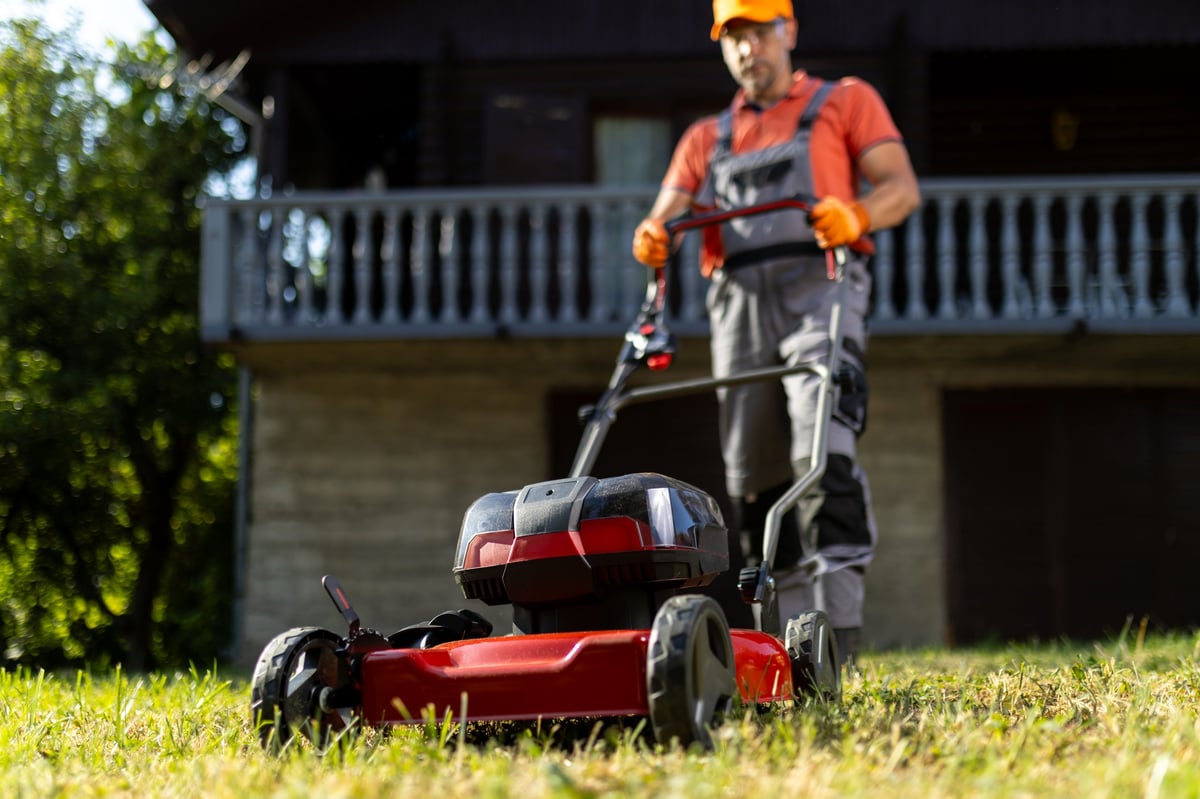 D & D Lawncare team member maintaining a lawn
