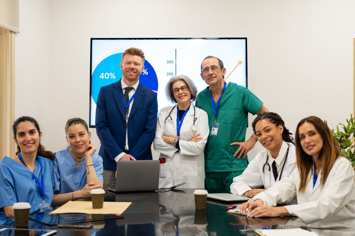 Healthcare professionals from different generations collaborating in modern conference room