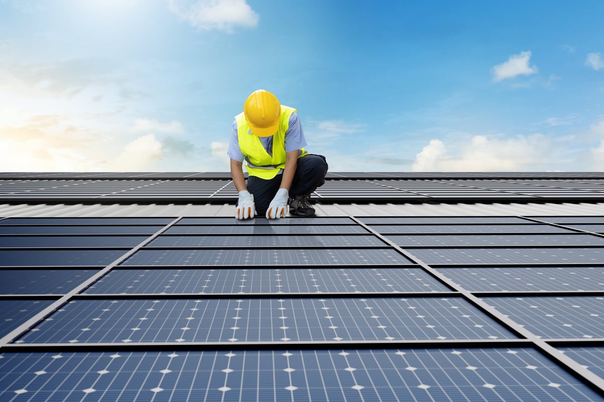 Solar technician repairing system components