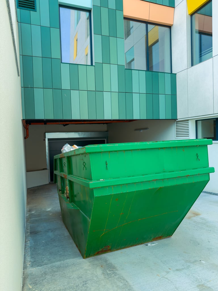 Dumpster in urban setting between buildings