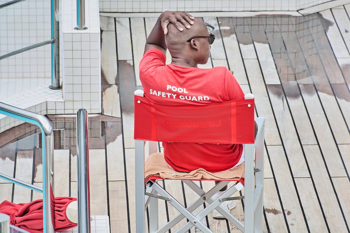 Professional lifeguard monitoring swimming pool