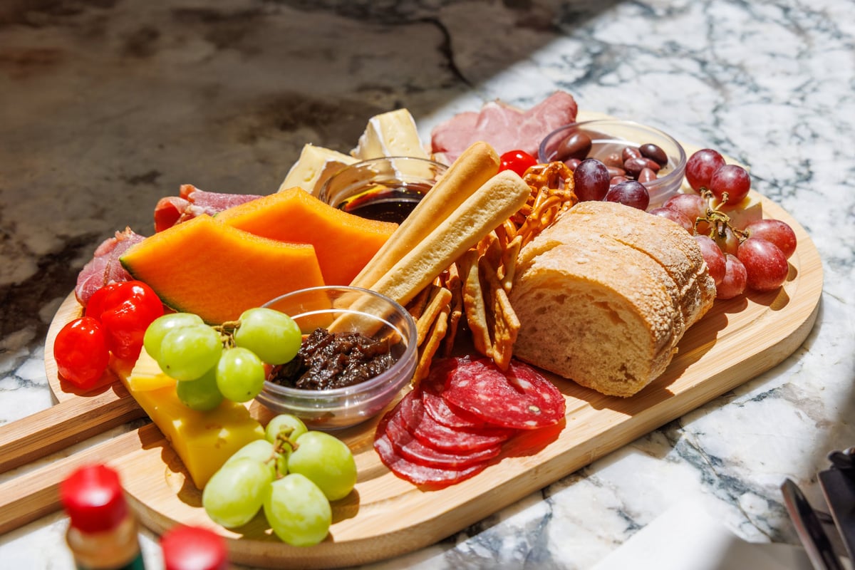 Antipasti board served on an outdoor cafe table, perfect accompaniment to wine and relaxed dining