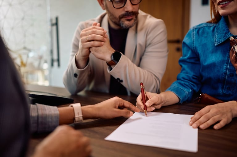 Couple signing documents with professional