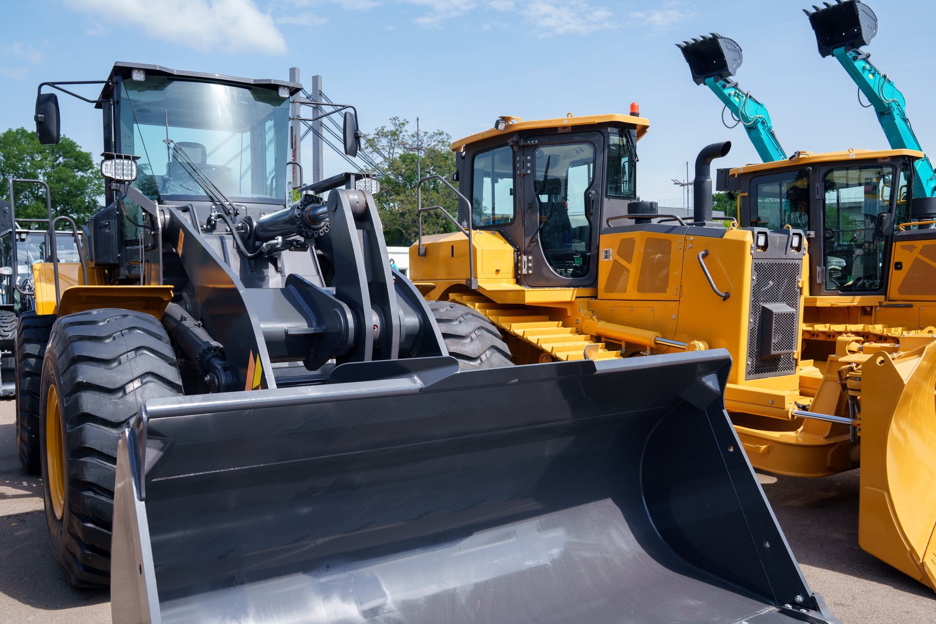 A dealer lot lined with new tractors and heavy equipment for sale