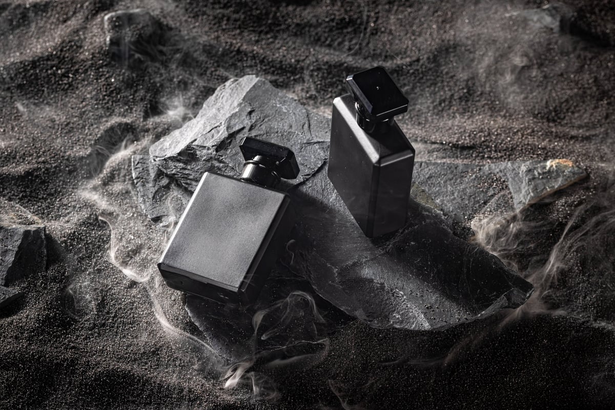 Luxury perfume bottle on dark rock — curated selection