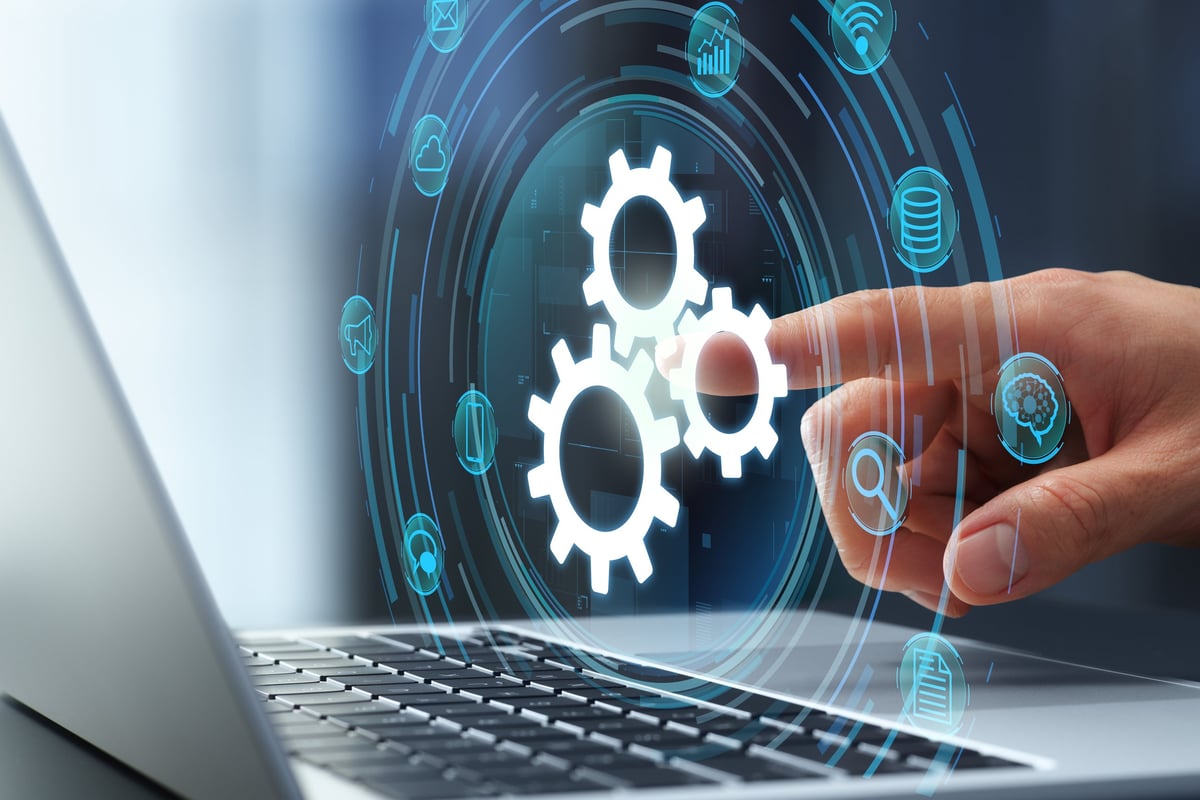 Business owner setting up automated systems on a laptop, representing streamlined business processes