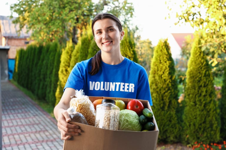 Volunteers packing care packages with food and essentials