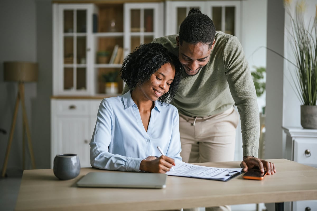 Couple reviewing financial documents together while rebuilding credit