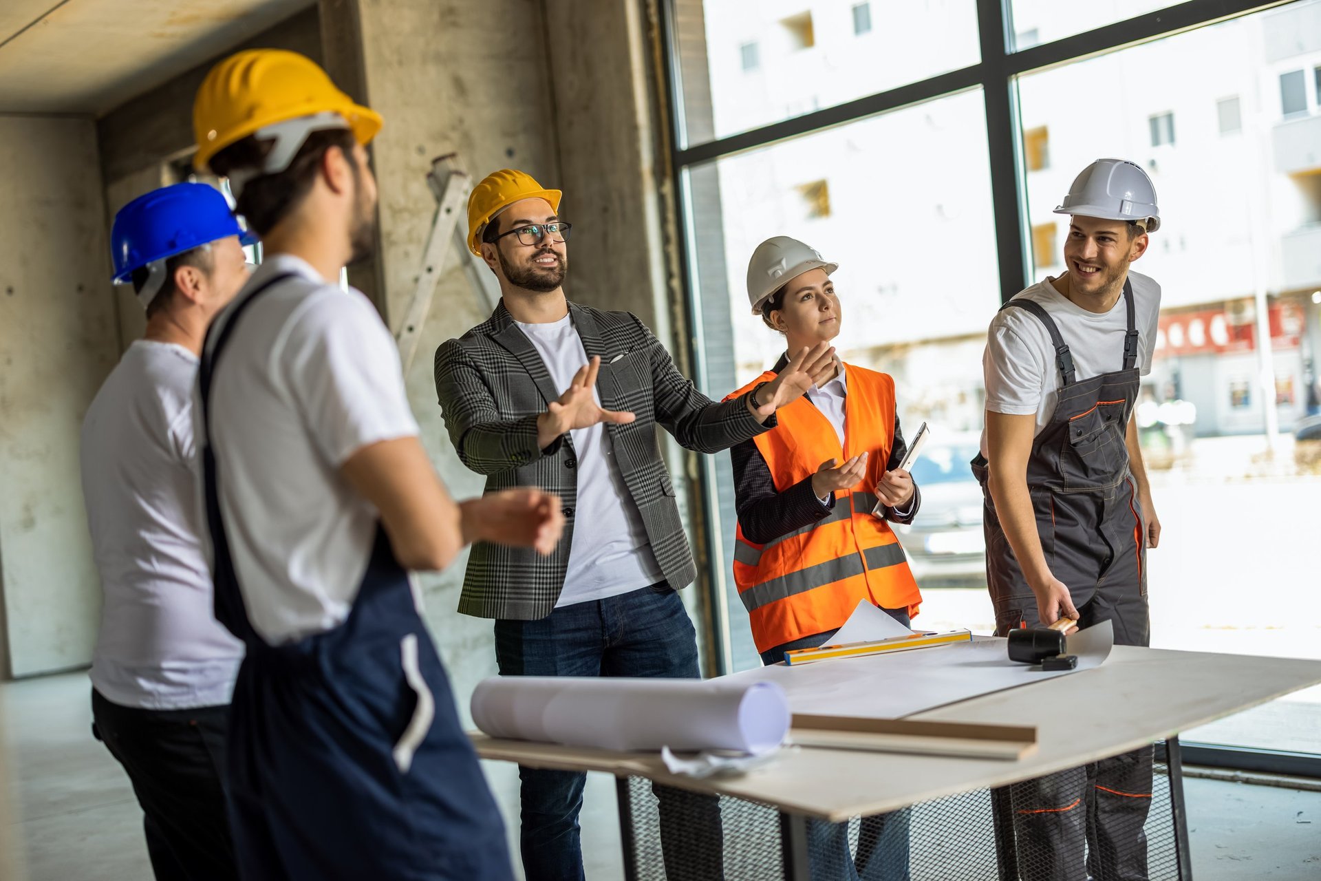 PBL construction manager reviewing plans on a jobsite in Connecticut