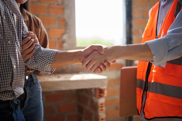 Homeowner shaking hands with construction engineer