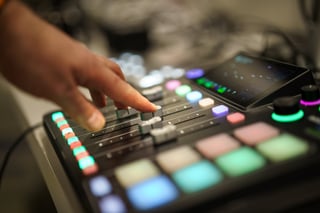 Closeup of hands on faders