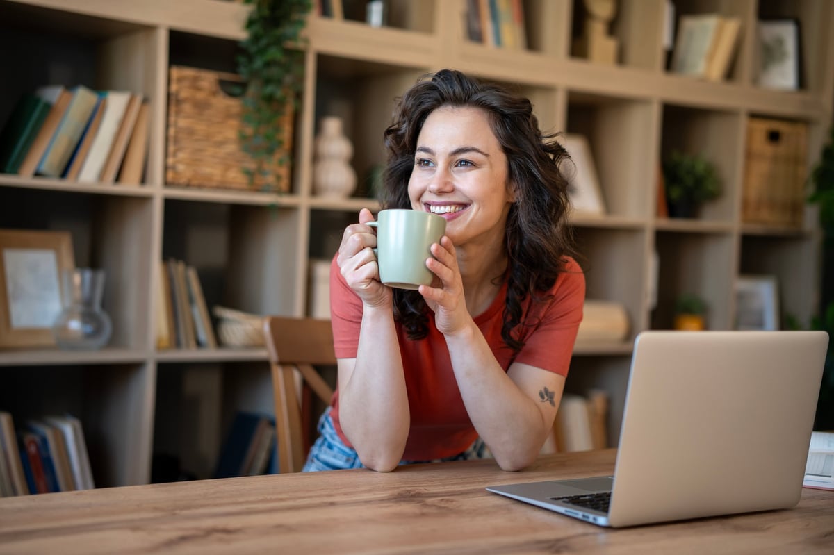 Freelancer working on her laptop at a quiet home office desk