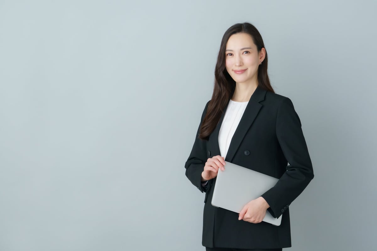 Professional in suit with laptop, representing Amazon career opportunities