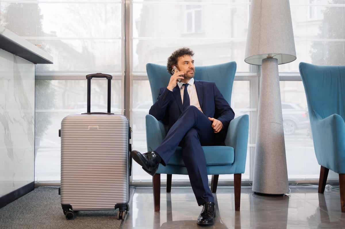 International investor reviewing property financing details from a hotel lobby