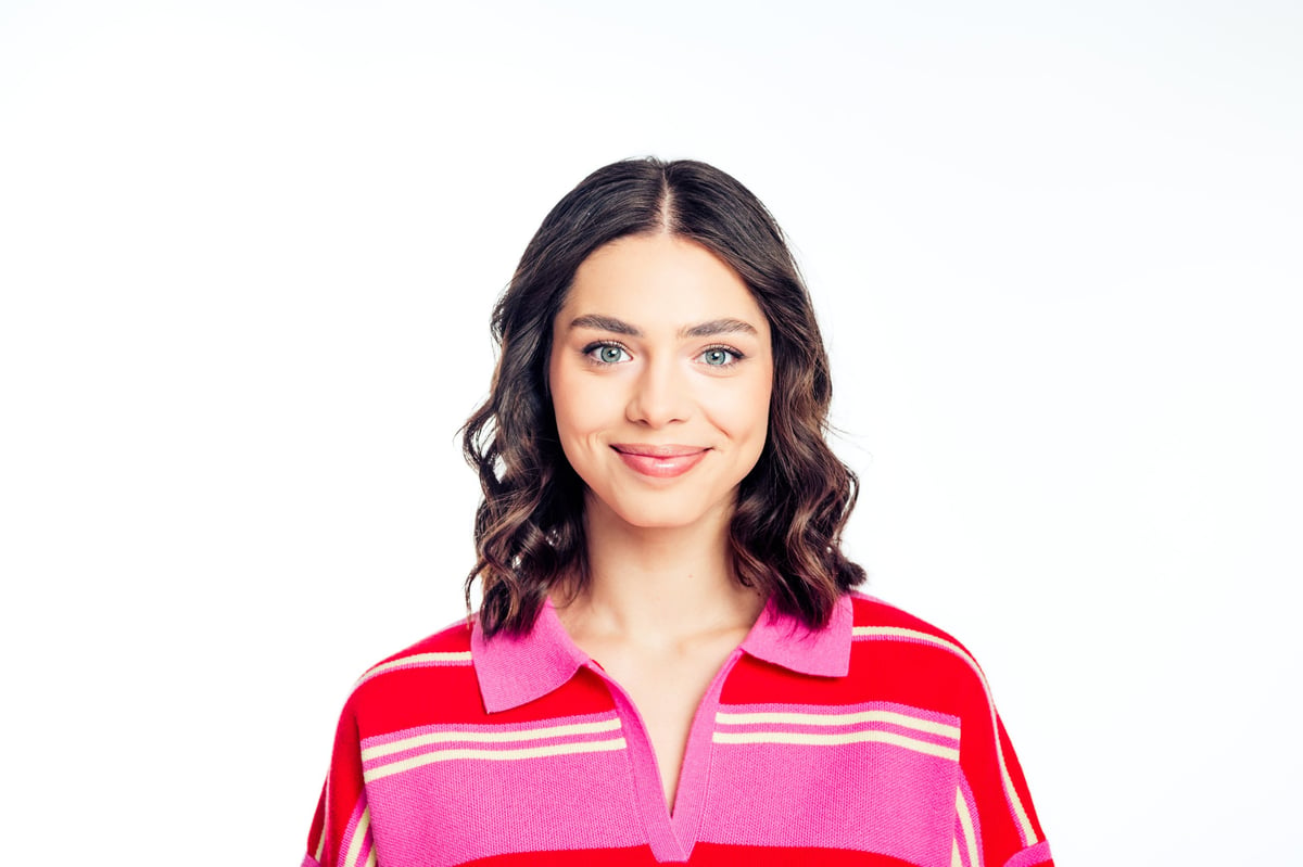 A young woman in her twenties with a warm, confident smile, the kind of patient who is heard