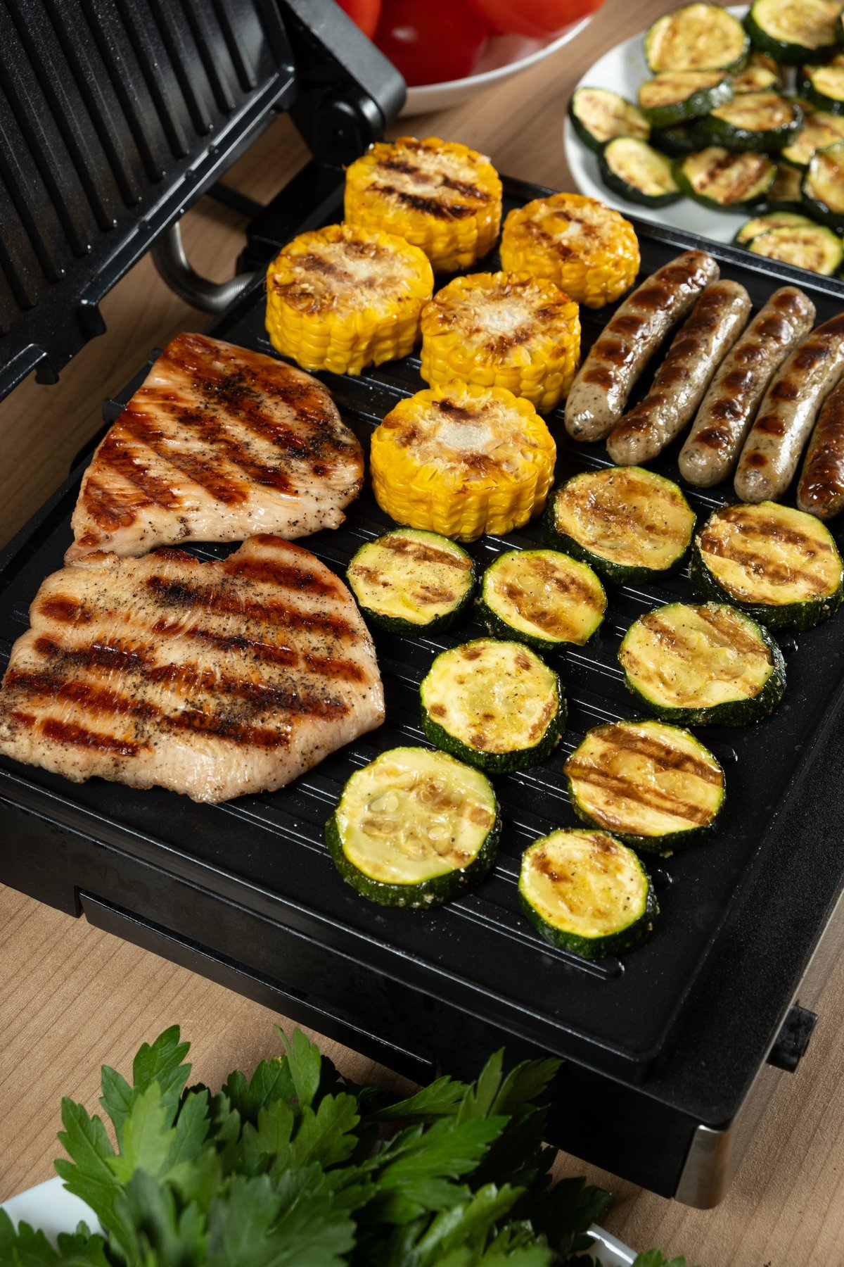 VORA electric grill sizzling with meat and vegetables — indoor BBQ perfection