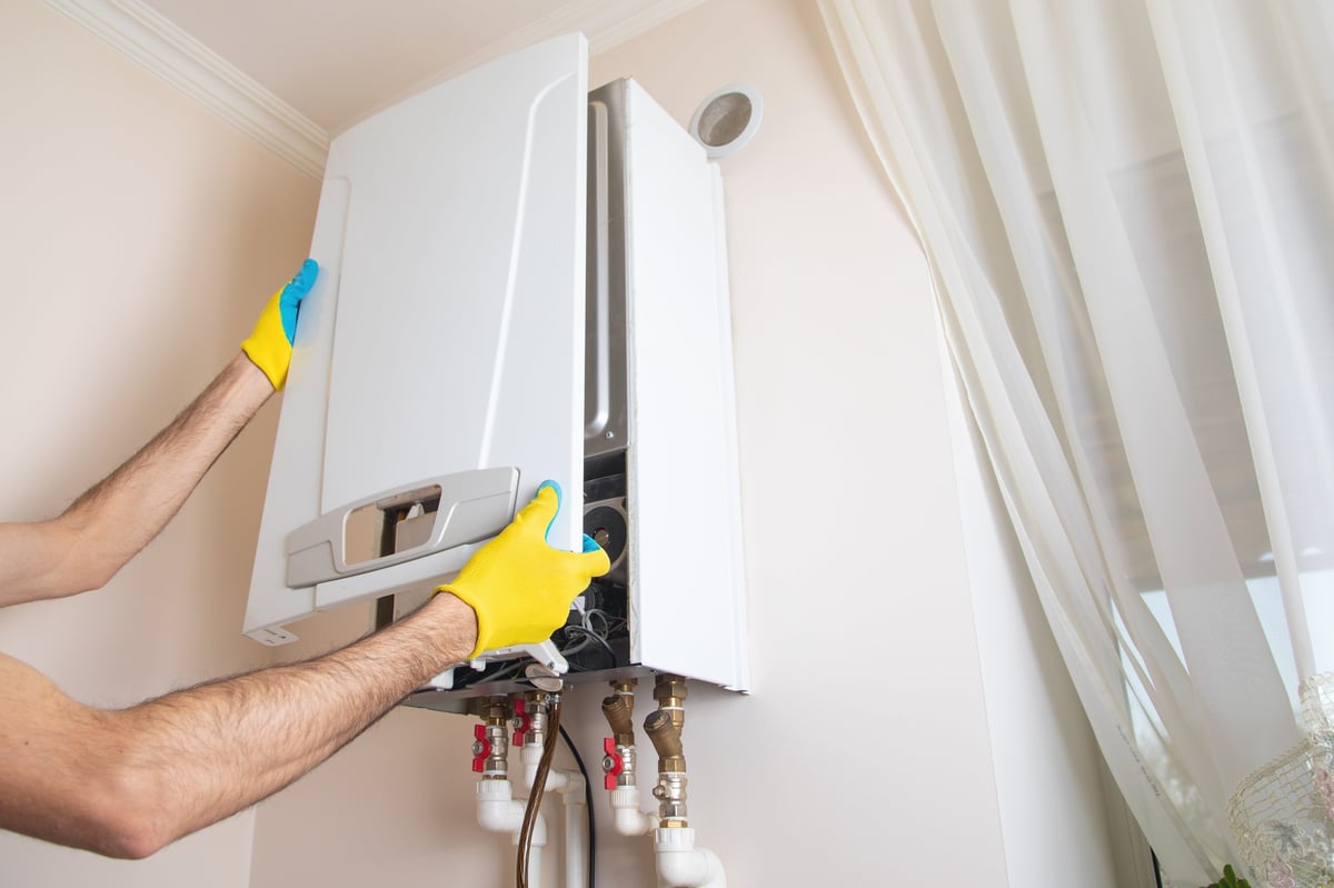 Professional plumber repairing a heating system in an apartment