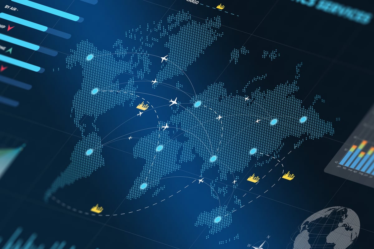 Professional analysing global supply-chain data and shipping routes on a computer monitor