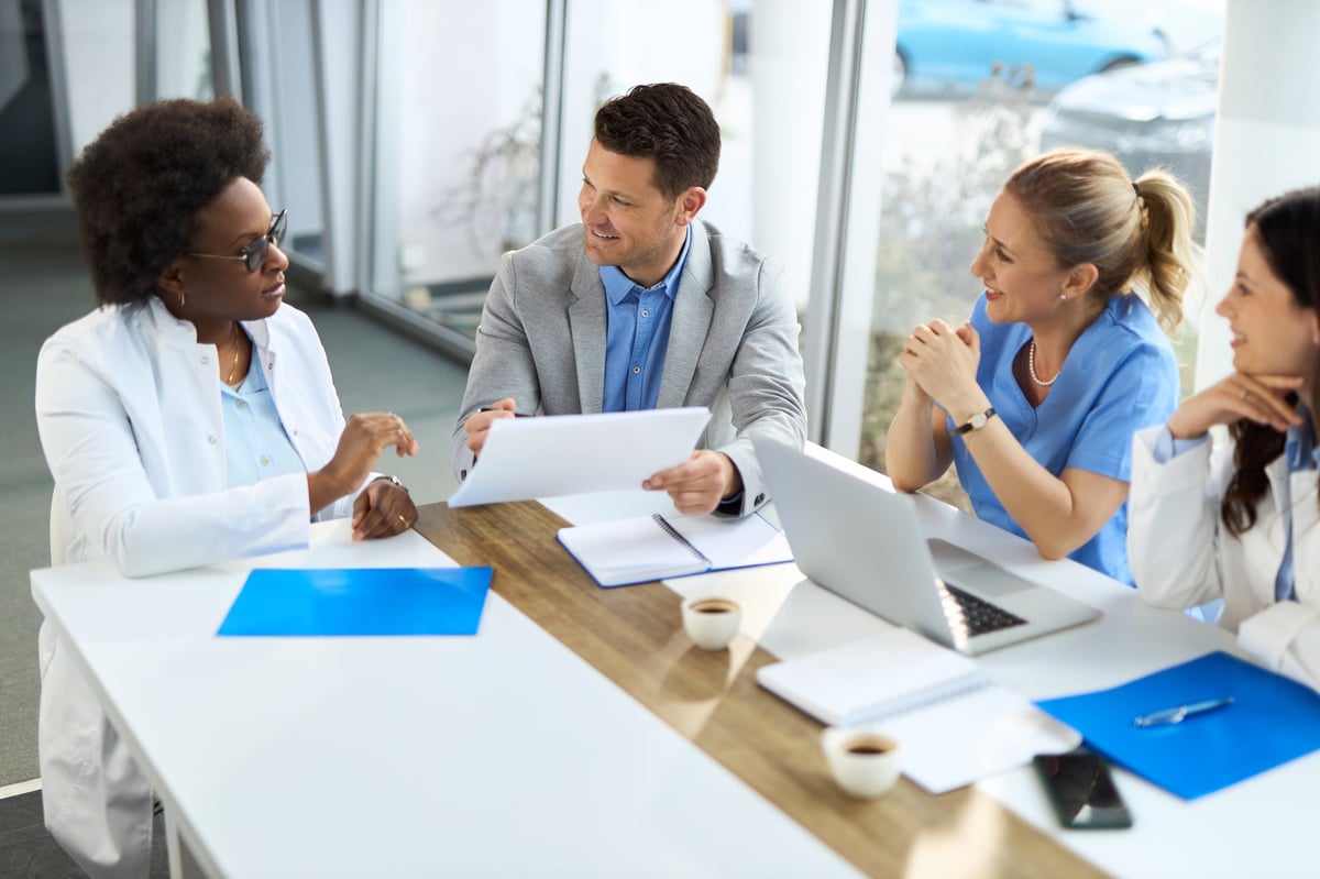 Medical experts having a meeting with male administrator in the hospital