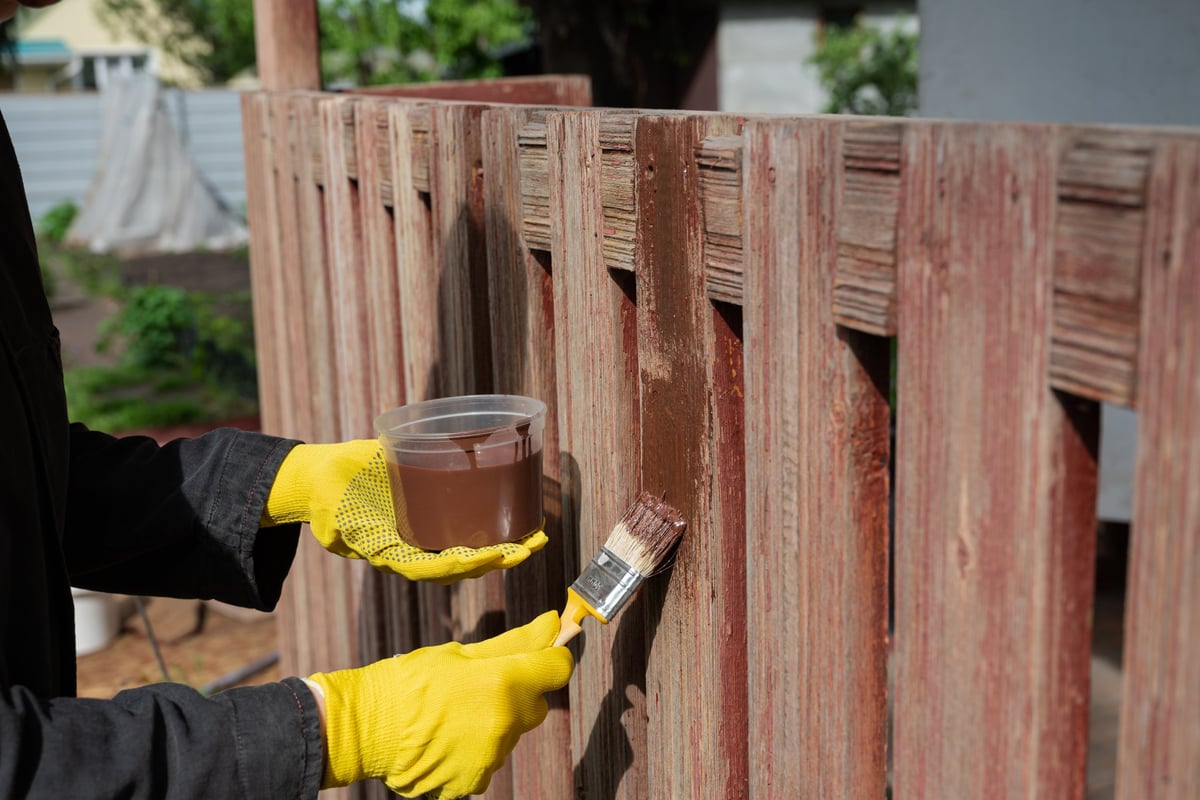 Evenly stained wood privacy fence panels forming a clean, uniform boundary