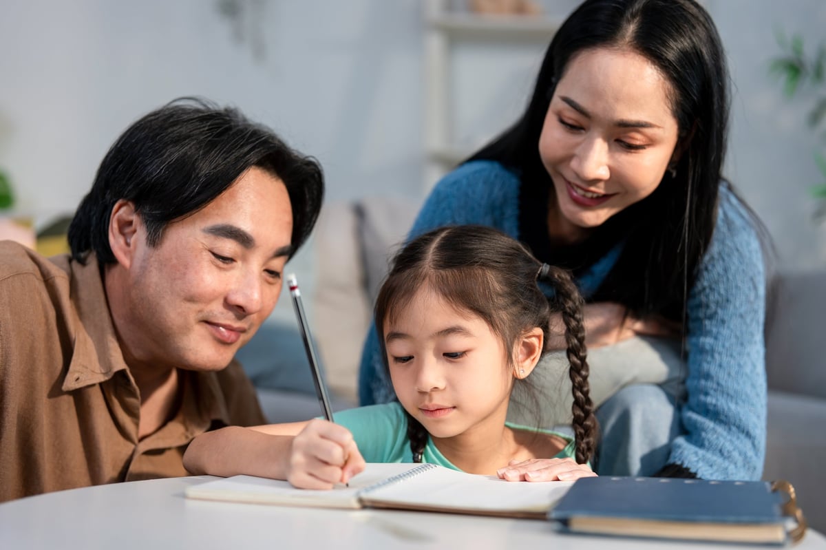 A school counselor guiding a Lighthouse family through scholarship and enrollment information