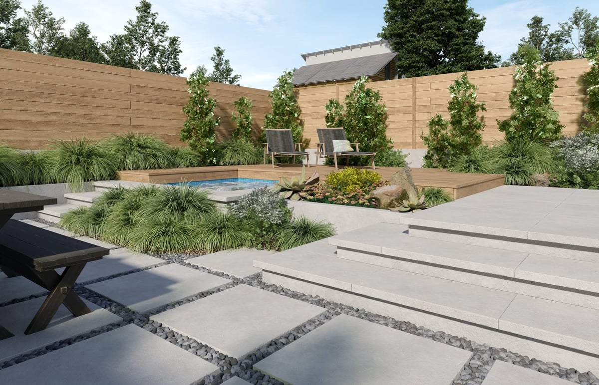 Pool patio with large rectangular pavers separated by turf joints and a stone wall behind