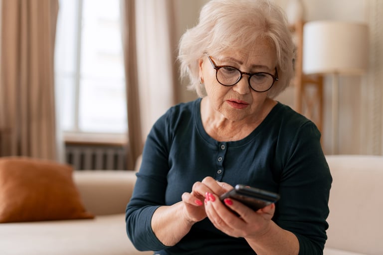 Woman looking at her smartphone with a gentle smile, ready to learn at her own pace